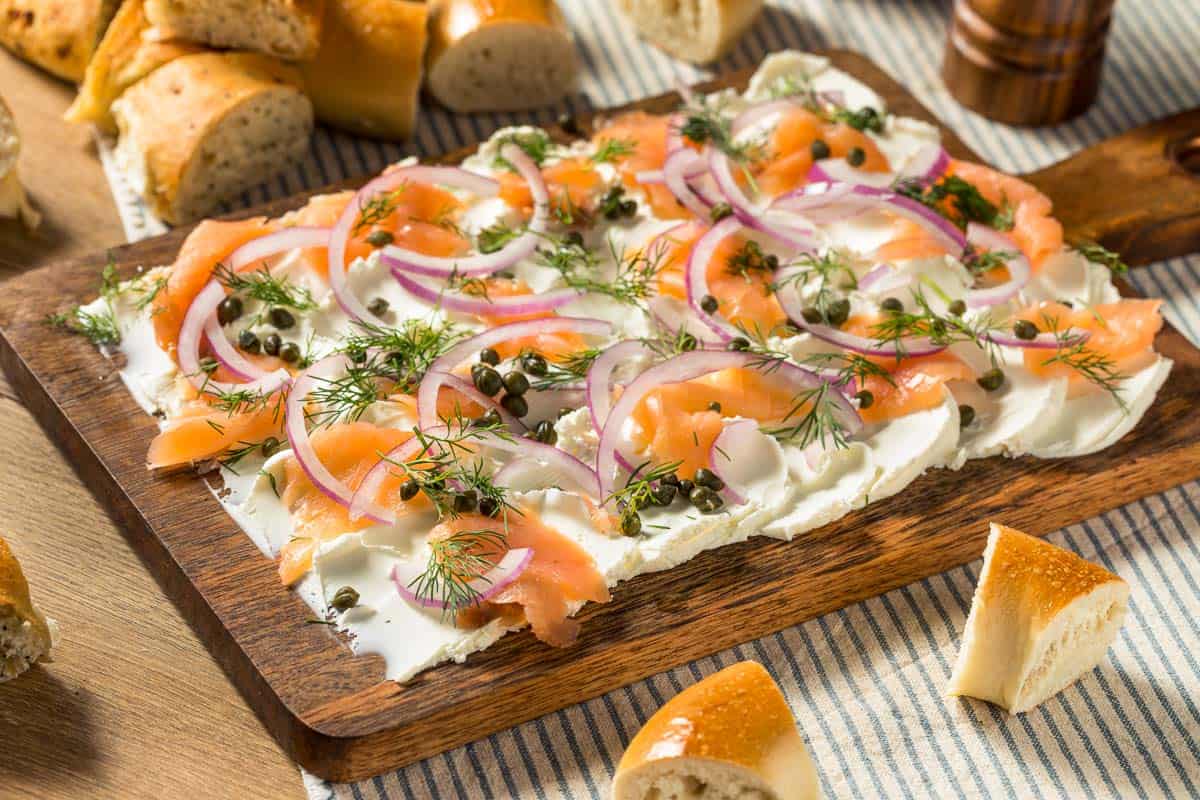 Butter Board with Salmon with bread cubes nearby.