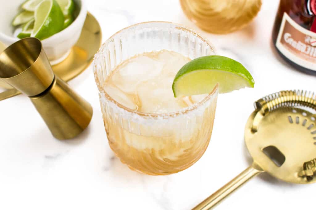 closeup of a lime garnish on a cadillac margarita.