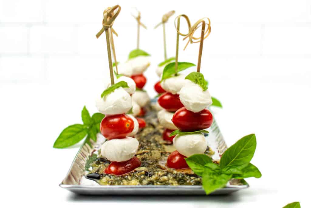 caprese skewers on a silver tray.