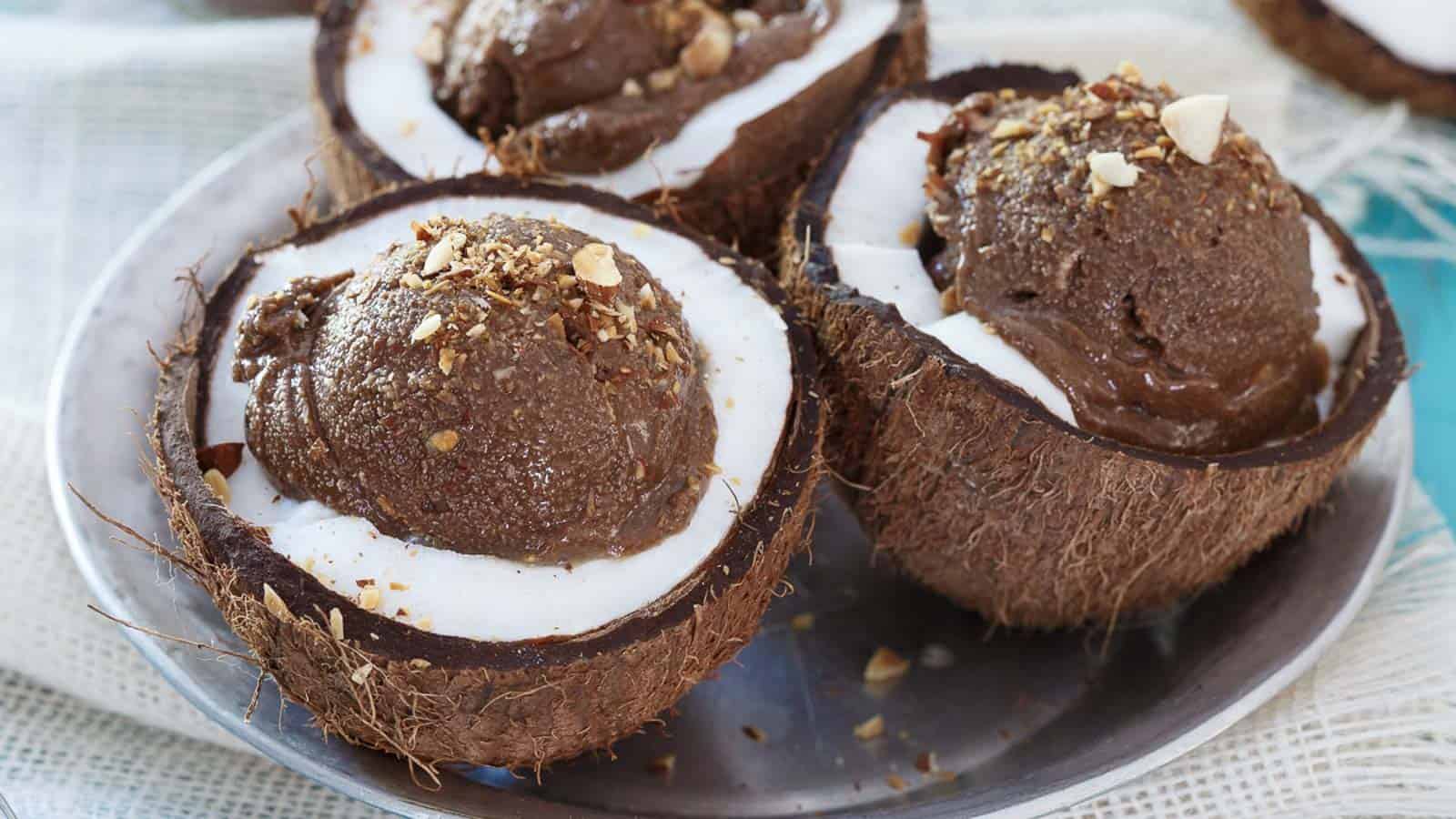 Chocolate coconut avocado ice cream in coconut shells.