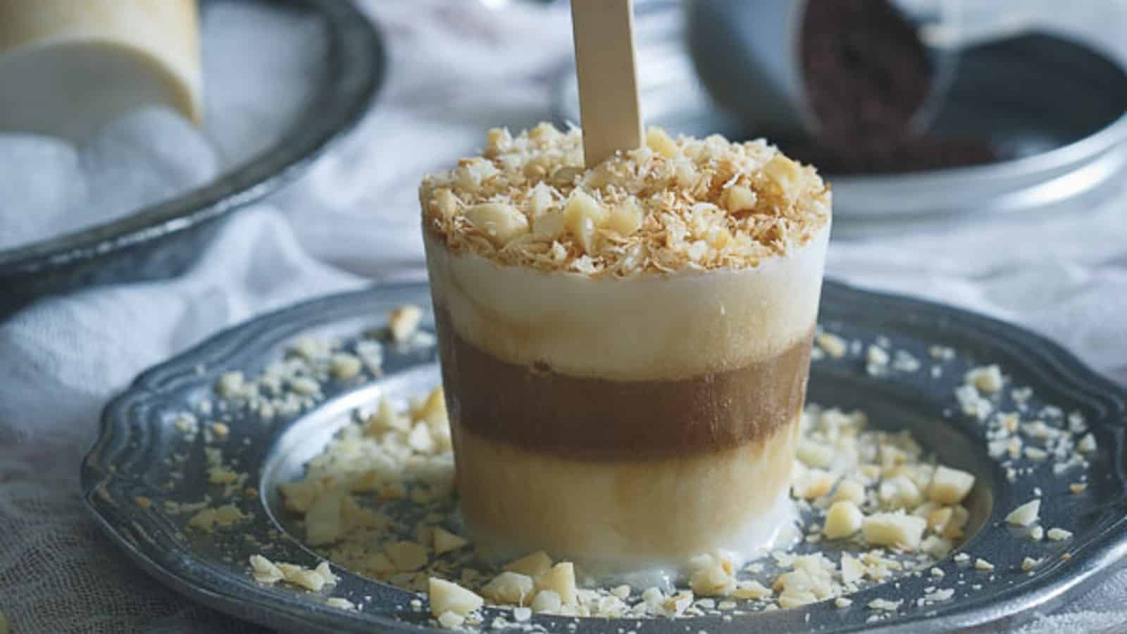 Coconut coffee cream ice pops on a metal plate.