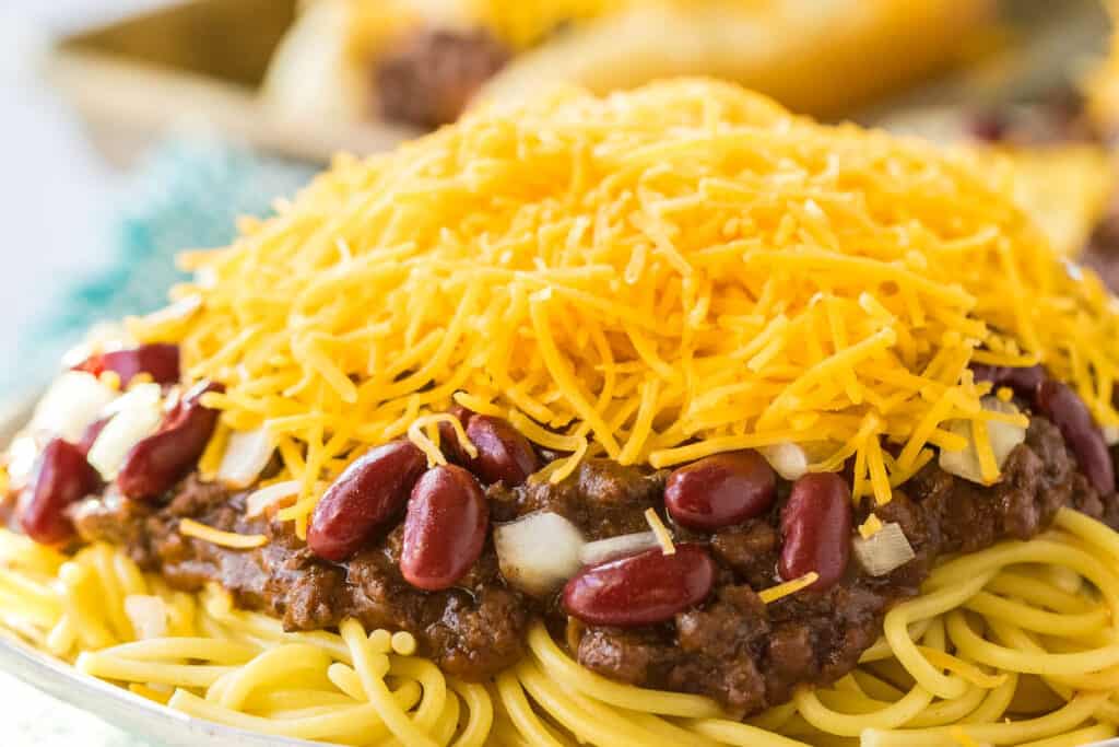 Cincinnatti chili on top of spaghetti and covered with cheese, beans and onions.