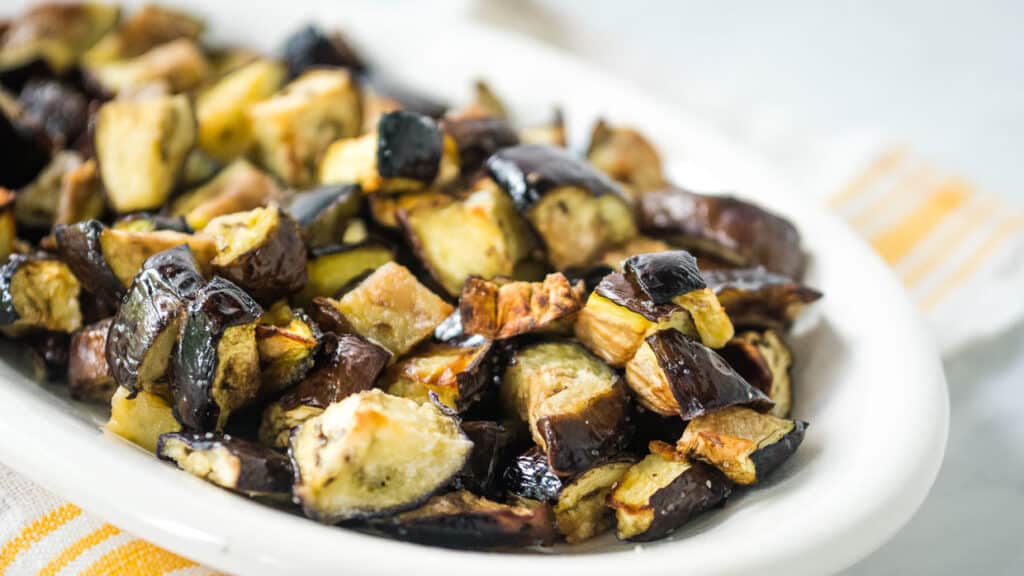 Eggplant on a white plate after air frying.