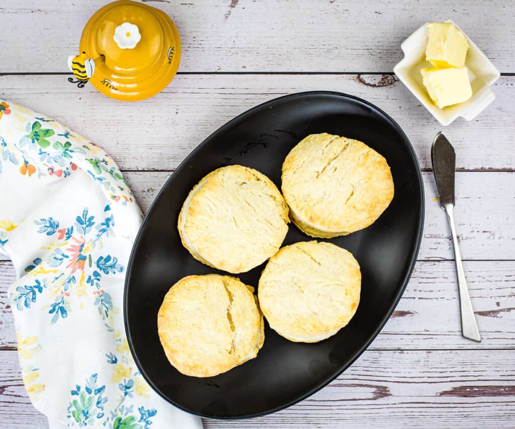 A top-down image of smoked biscuits on black plate.