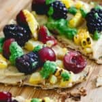 Grilled hummus flatbread with fruit and corn.