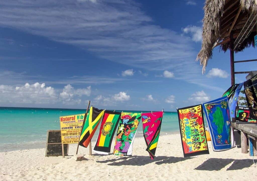 Colorful beach towels on a line by the sea.