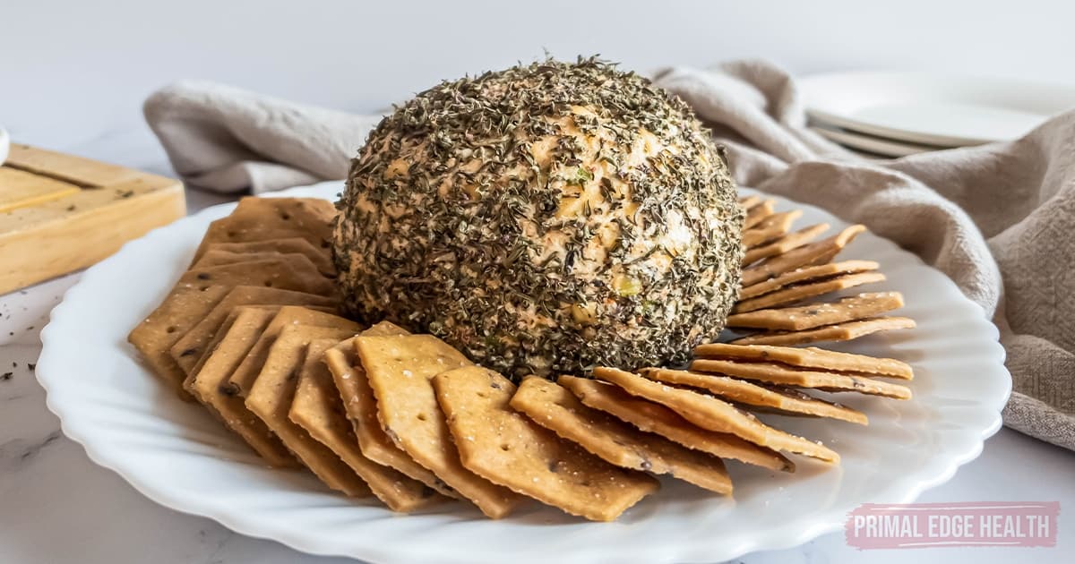 A picture of a nut-free cheese ball with crackers on a plate.