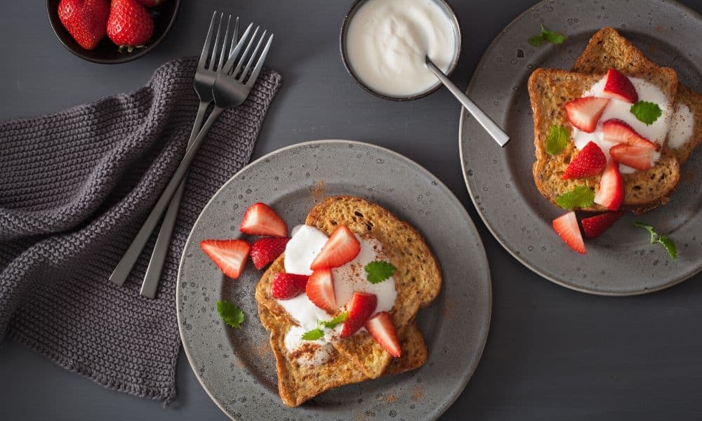 Two servings of keto french toast on grey plates.