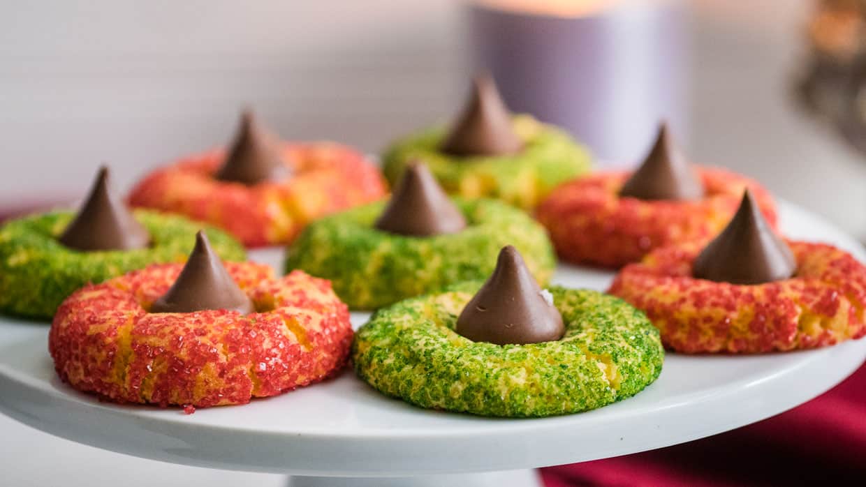 Thumbprint cookies with red and green sprinkles topped with a Hershey's Kiss.