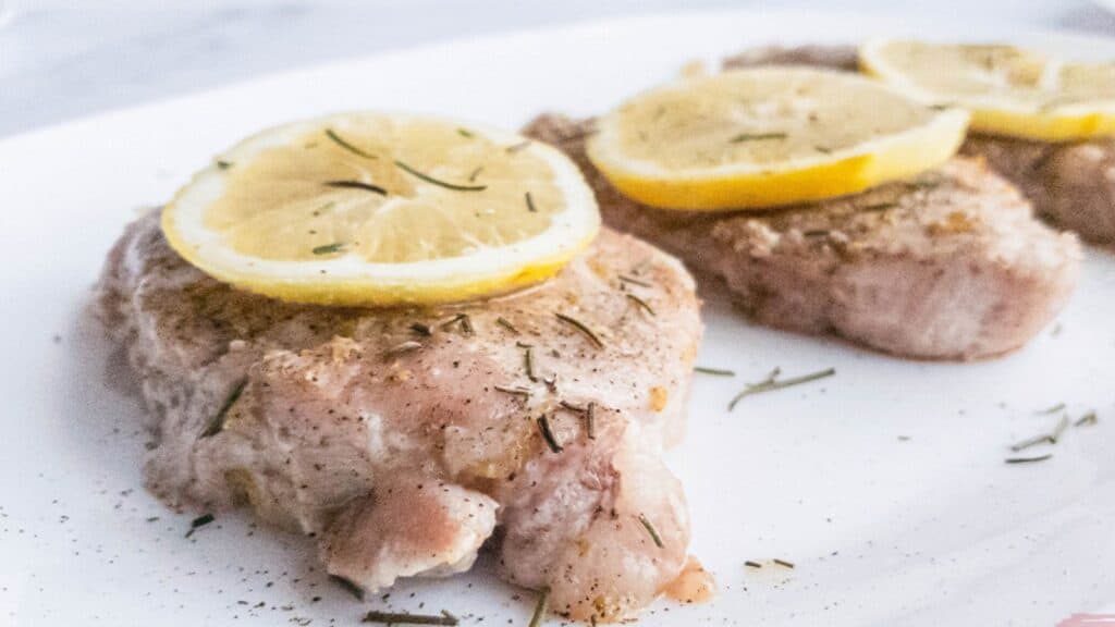 Lemon Pepper Pork Chops with rosemary garnish