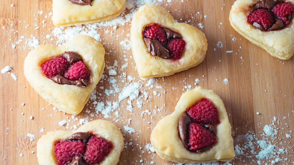 5-ingredient heart shaped pastries with raspberries and chocolate.