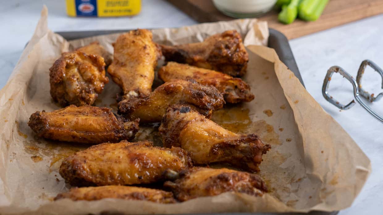 Chicken wings are sizzling on a baking sheet during the finger food frenzy.
