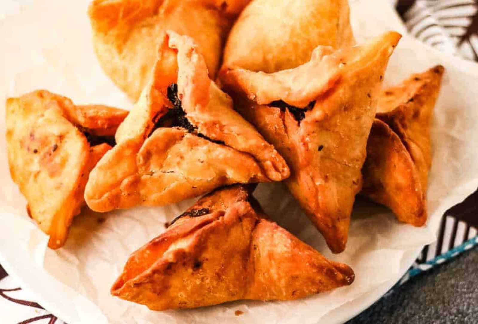 Low angle shot of fried onion samosas ready to serve.