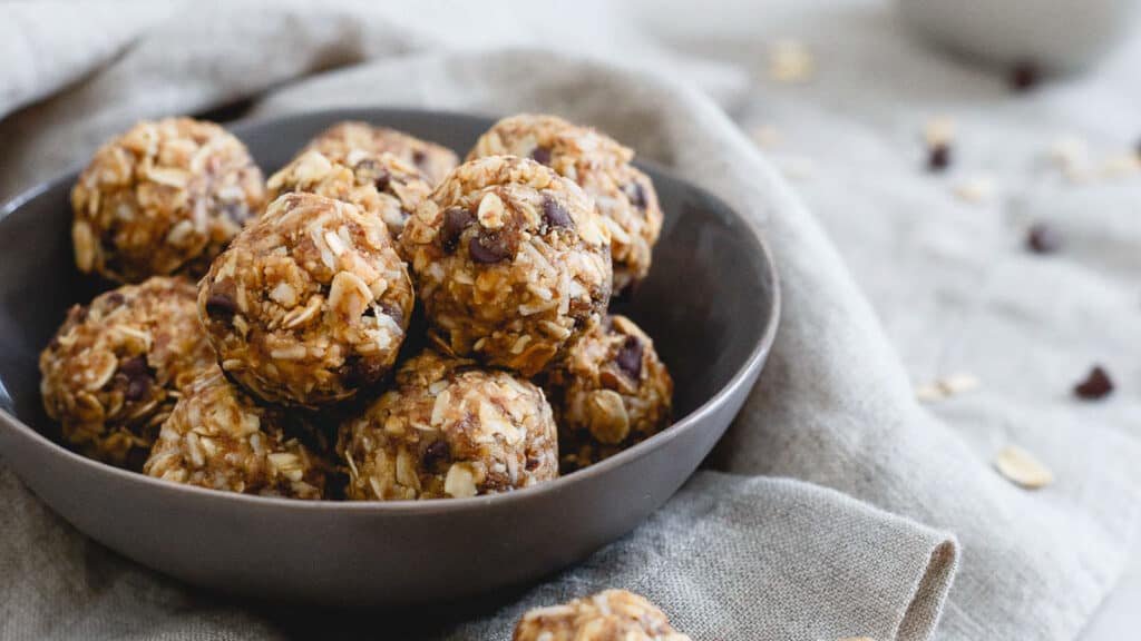 Peanut butter balls with chocolate chips in a bowl.