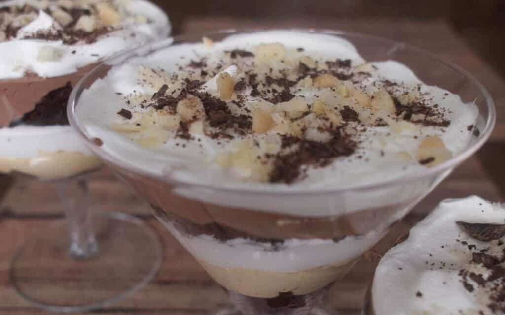 Layers of chocolate, peanut butter and whipped cream in a trifle glass.