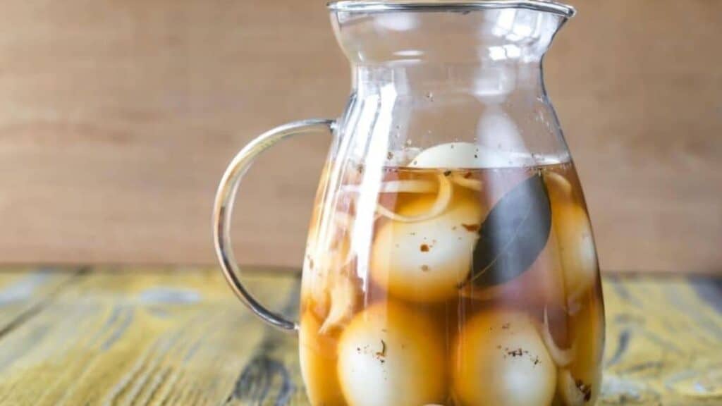 pickled eggs in glass pitcher