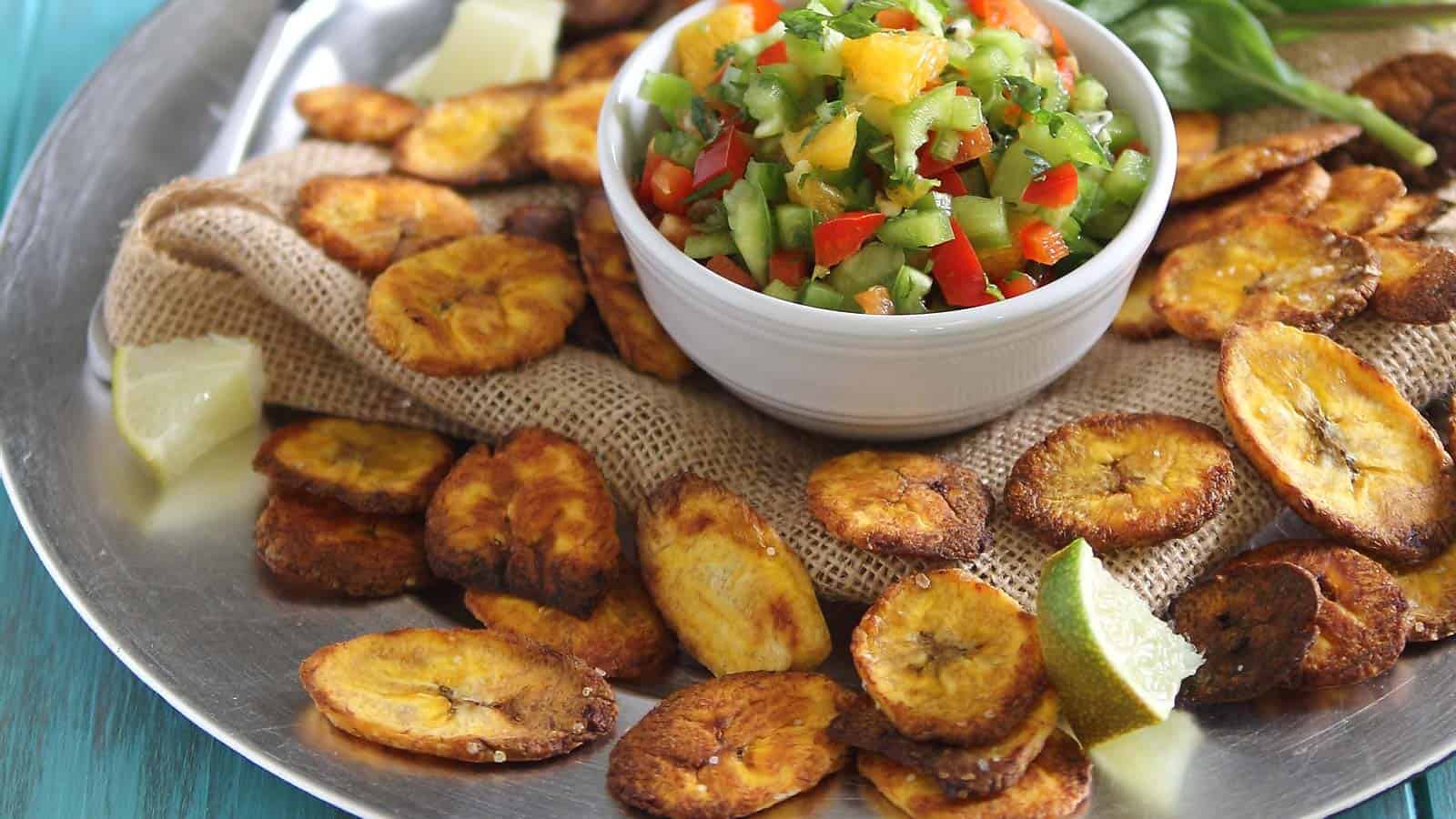 Plantain chips on a platter with salsa.