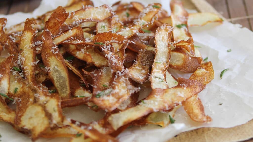 Potato strips on parchment paper.