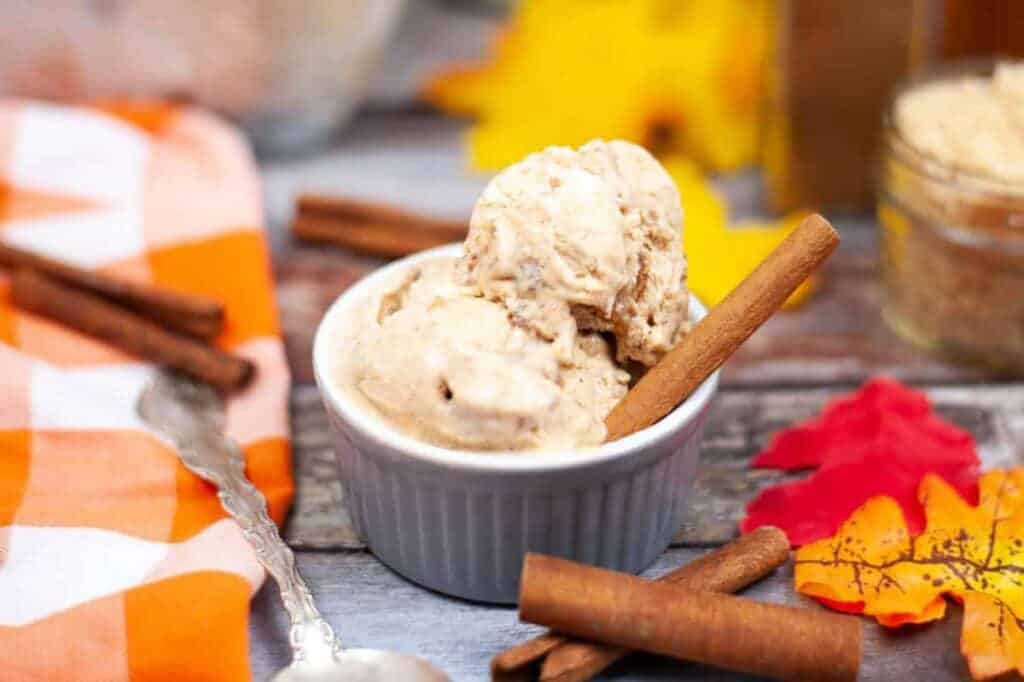 pumpkin spice ice cream in a ramekin with cinnamon sticks.