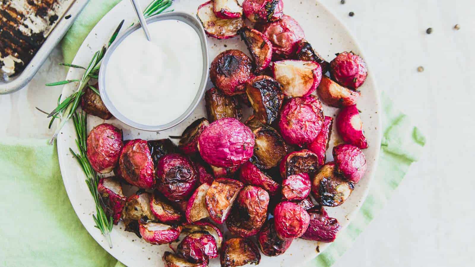 Rosemary honey roasted radishes on a plate with dipping sauce.