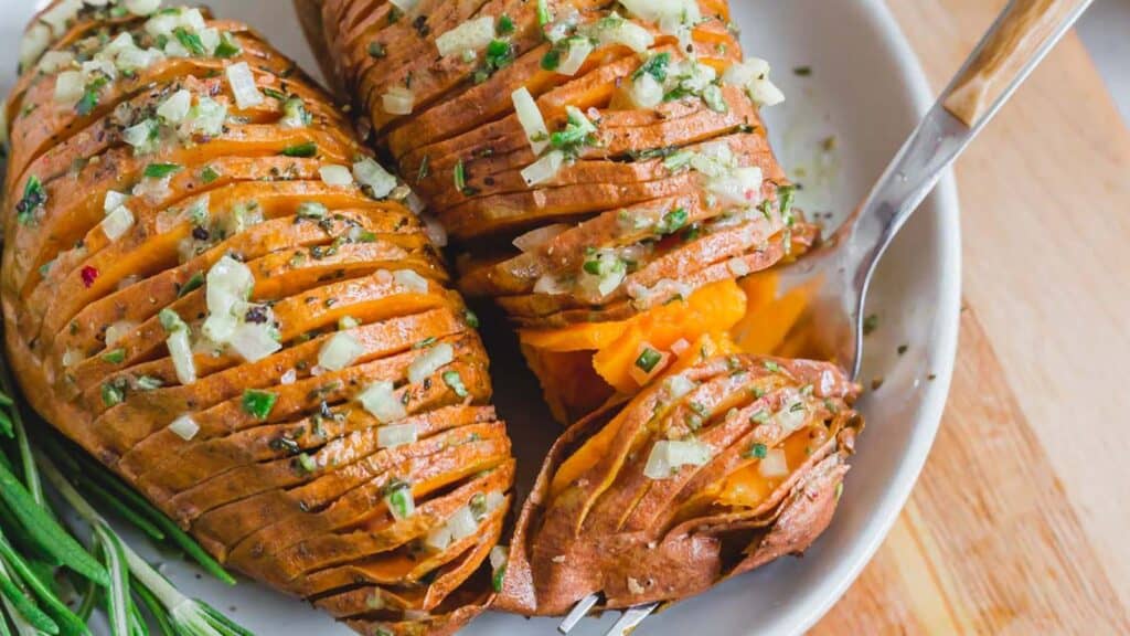 A forkful of rosemary hasselback sweet potatoes.