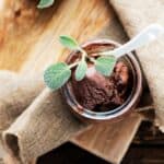 chocolate sage ice cream in glass cup from above sage garnish burlap napkin