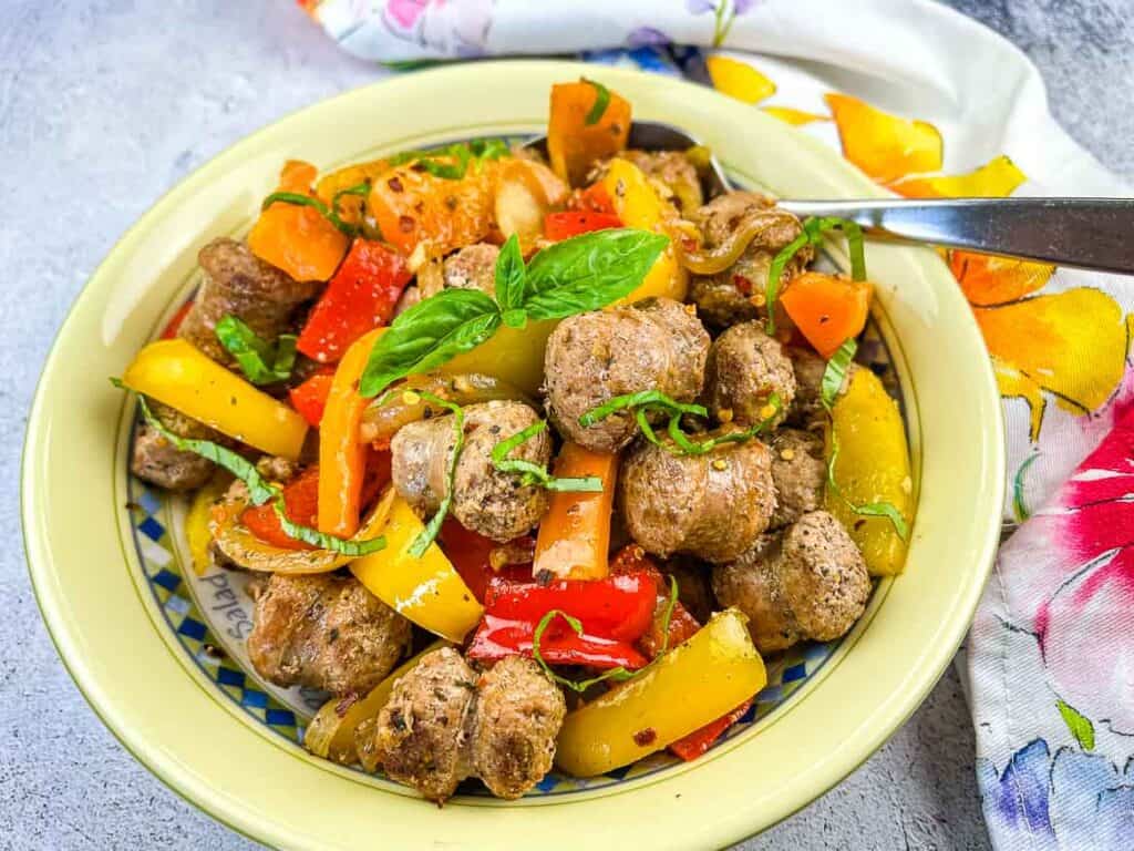 Blackstone Sausage & Peppers in a yellow serving bowl.