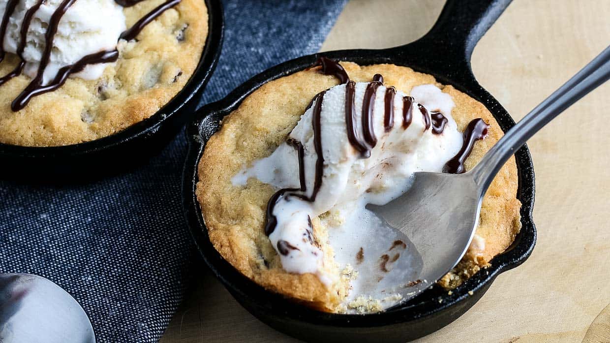 Chocolate chips skillet cookies topped with ice cream.