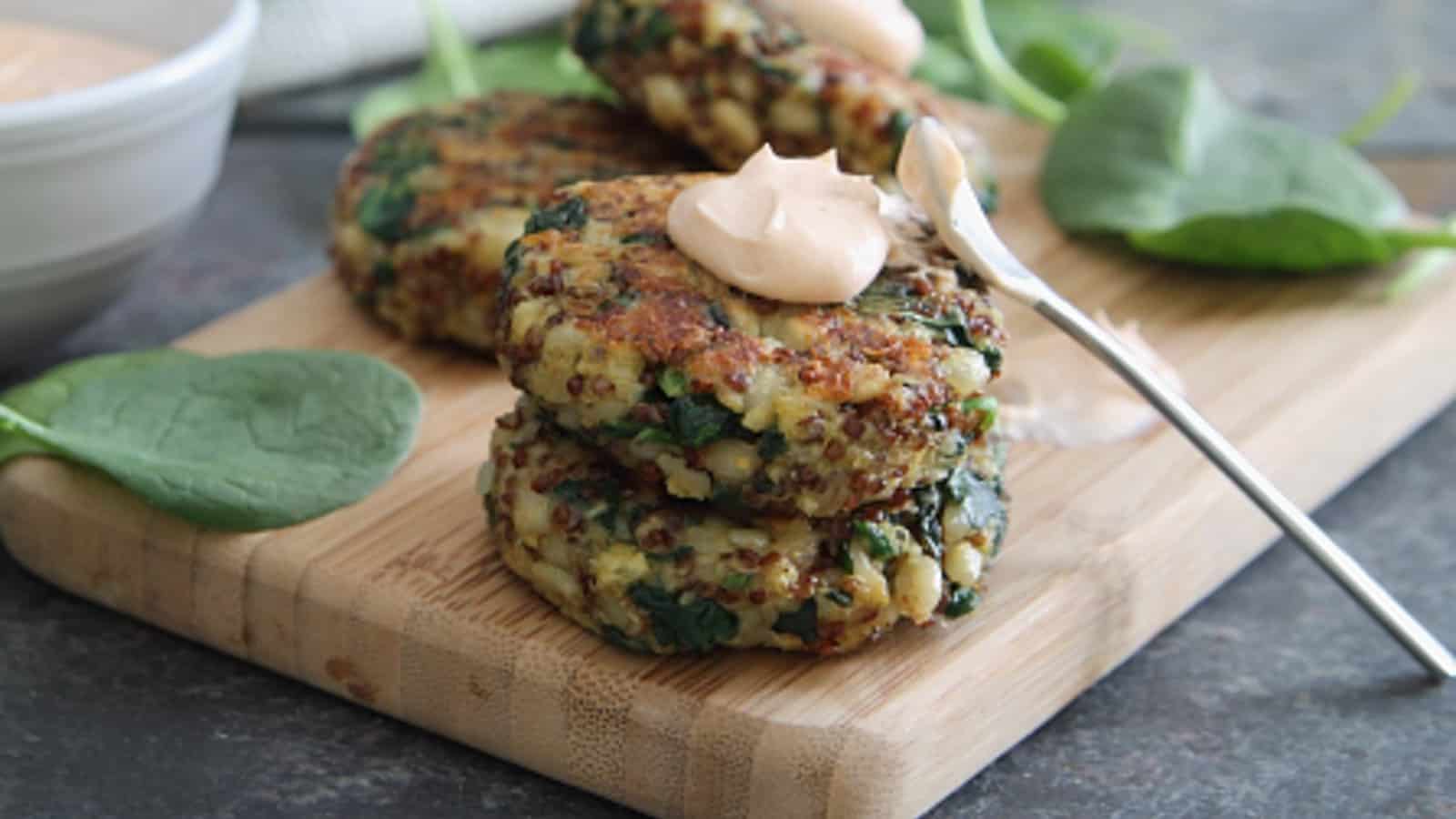 Spinach cheddar quinoa cakes topped with buffalo yogurt sauce.