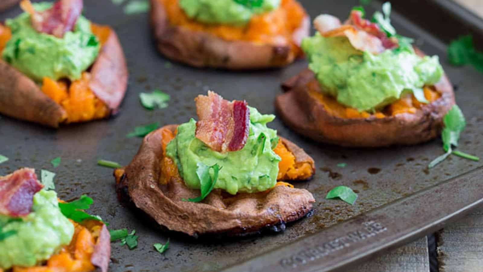 Sweet potato bites topped with guacamole and bacon.