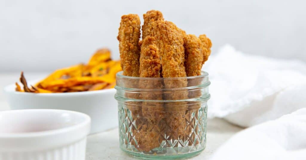 air fryer Tyson chicken fries in a mason jar with a white napkin.