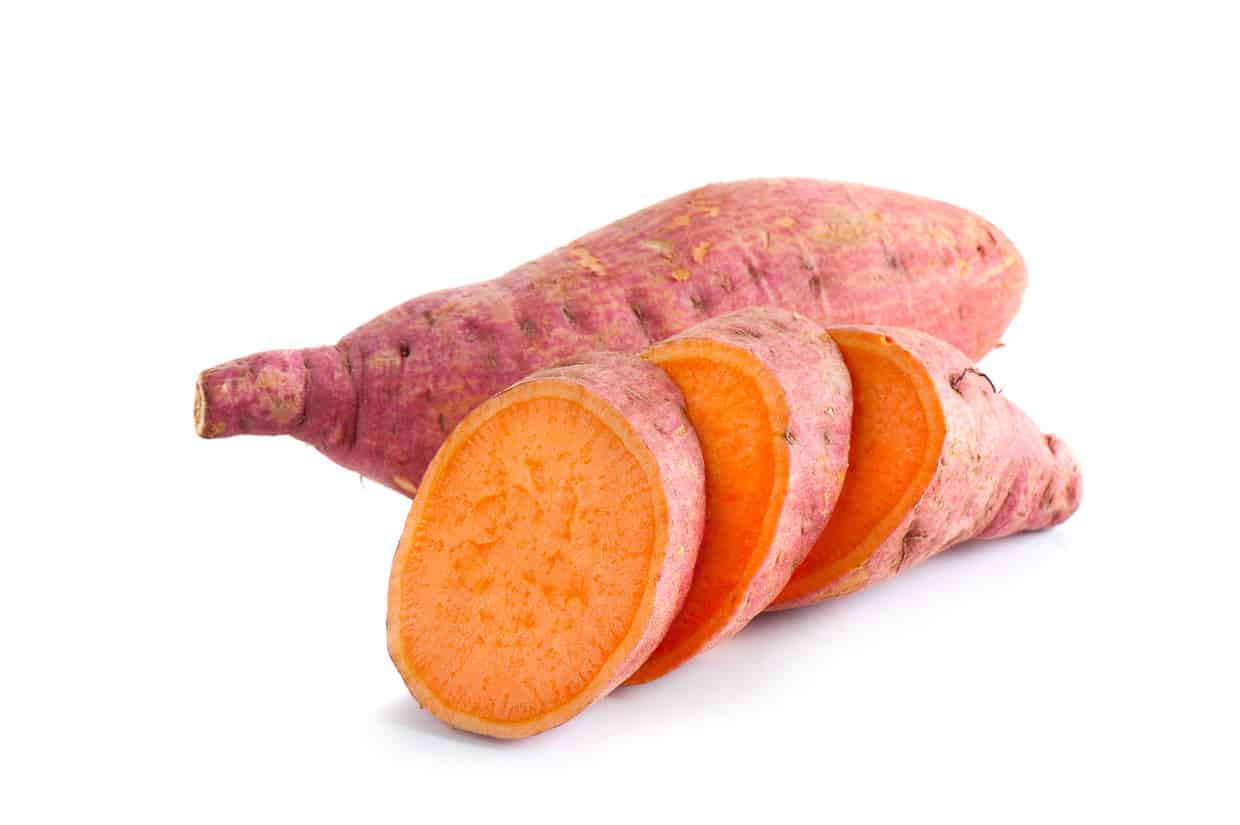 A whole sweet potato and one that's been sliced.