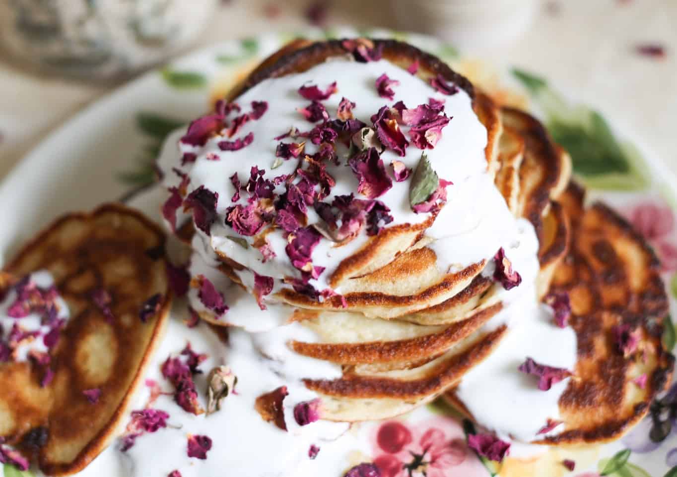 A close up on Russian pancakes with rose petals.