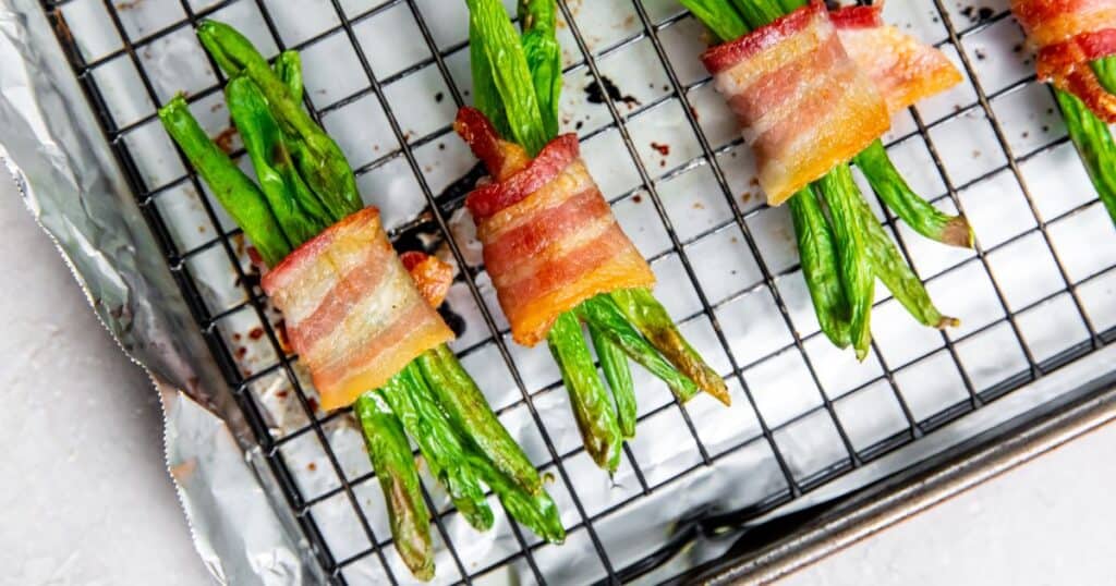 bacon wrapped green beans on a cooling rack