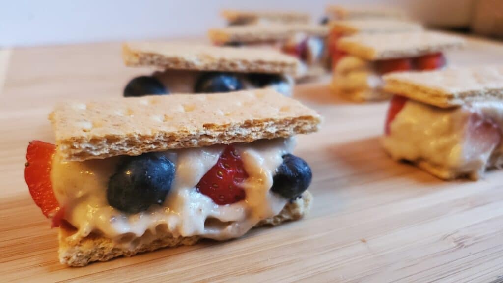 Banana ice cream sandwiches with strawberries and blueberries