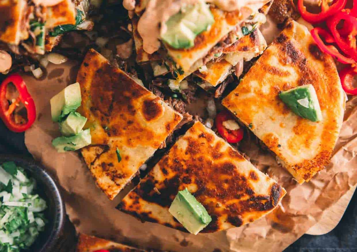 Sliced quesadilla with toppings.