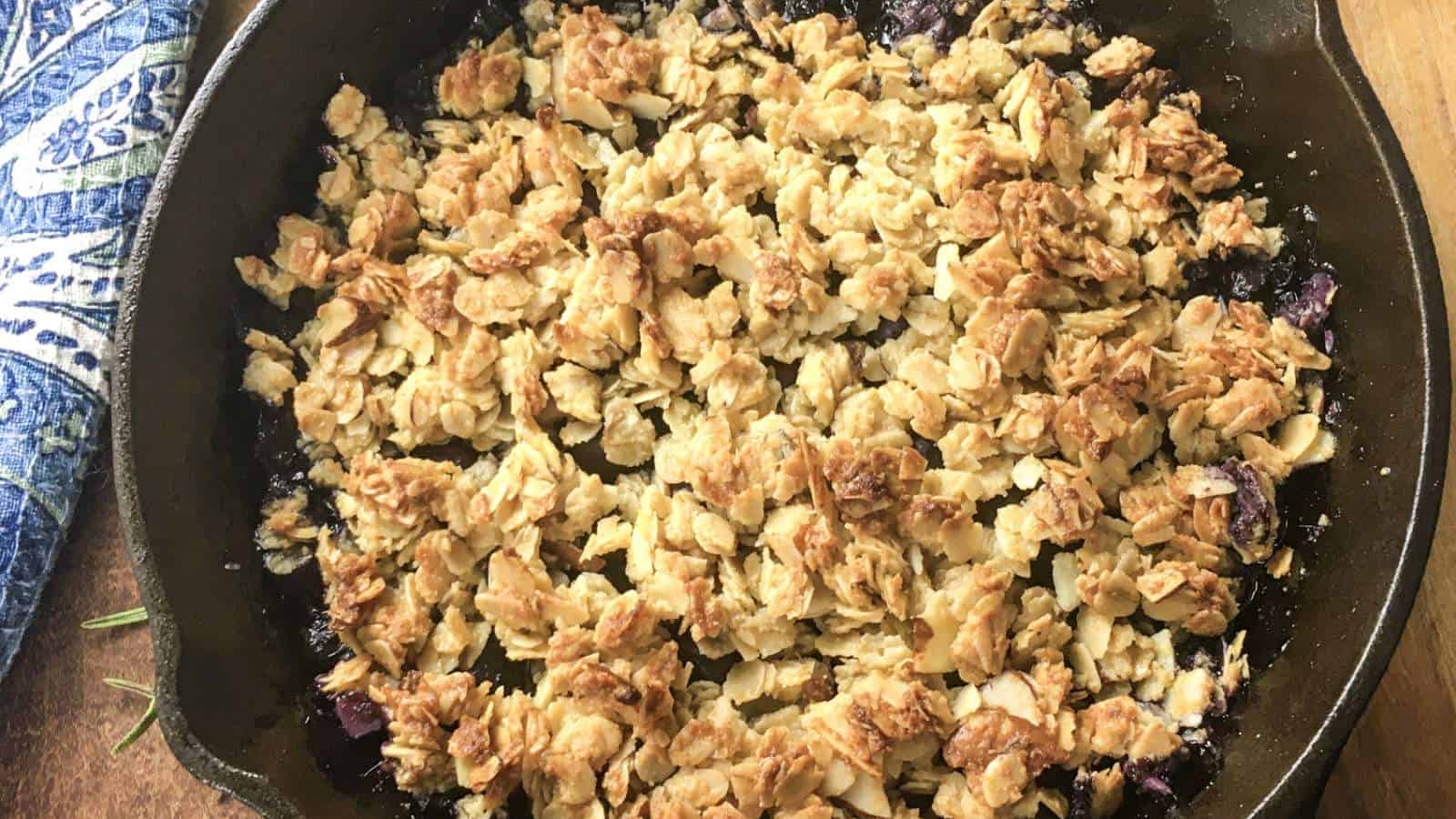 Blueberry crisp in a cast iron skillet.