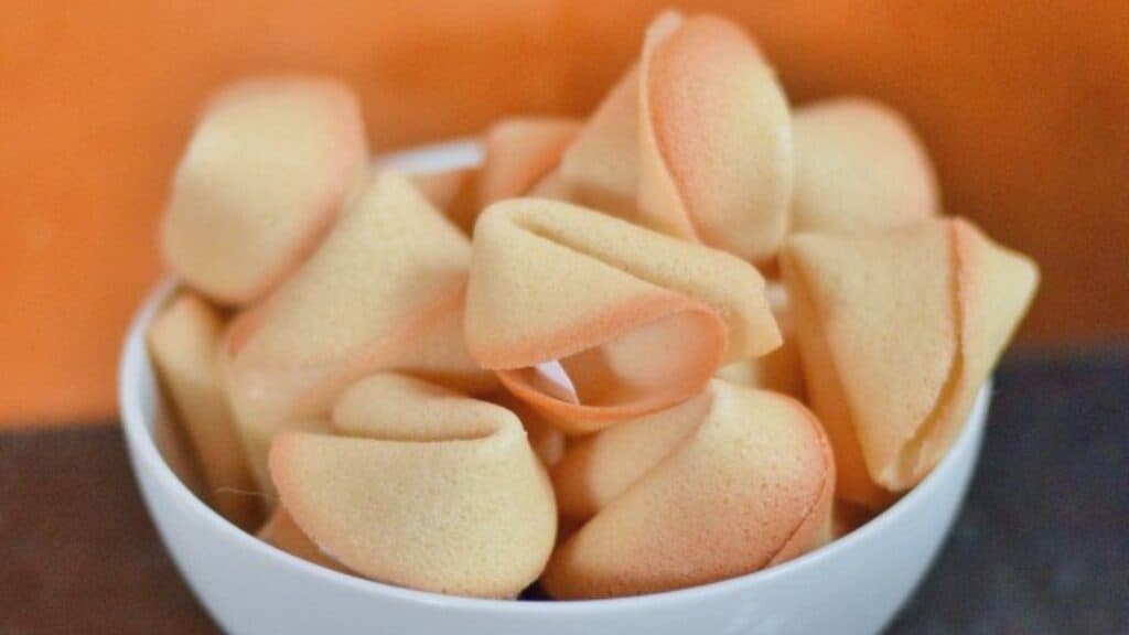 Image shows a Bowl filled with homemade fortune cookies.