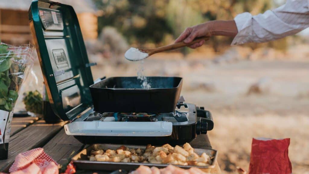 Cooking food at a campsite.