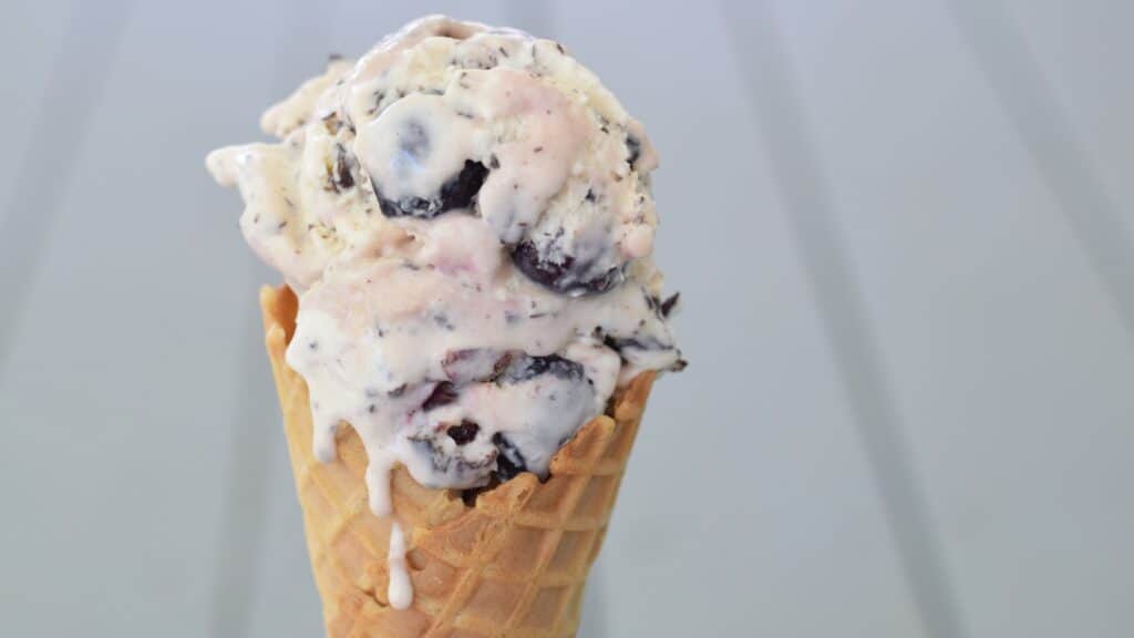 Cherry Chip ice cream in a cone with drips.