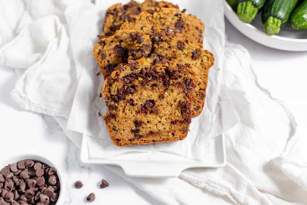A slice of chocolate chip zucchini bread on a plate.