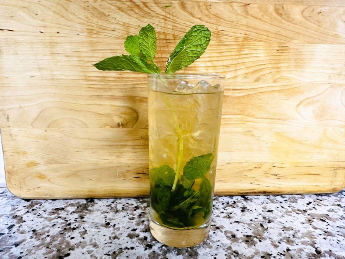 Mint Julep in clear glass with mint sprigs as garnish.
