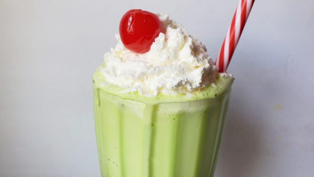 Copycat shamrock shake with whipped cream and cherry.
