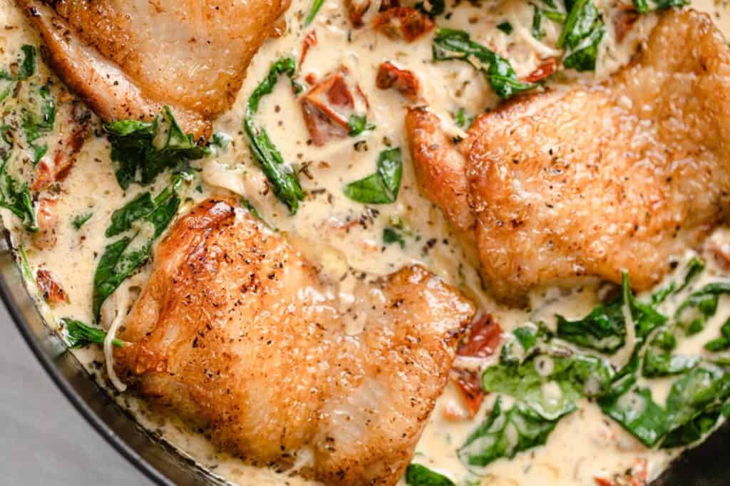 Creamy Tuscan chicken in a skillet.