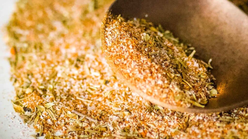 Closeup show of homemade blackening seasoning mix on a copper fork.