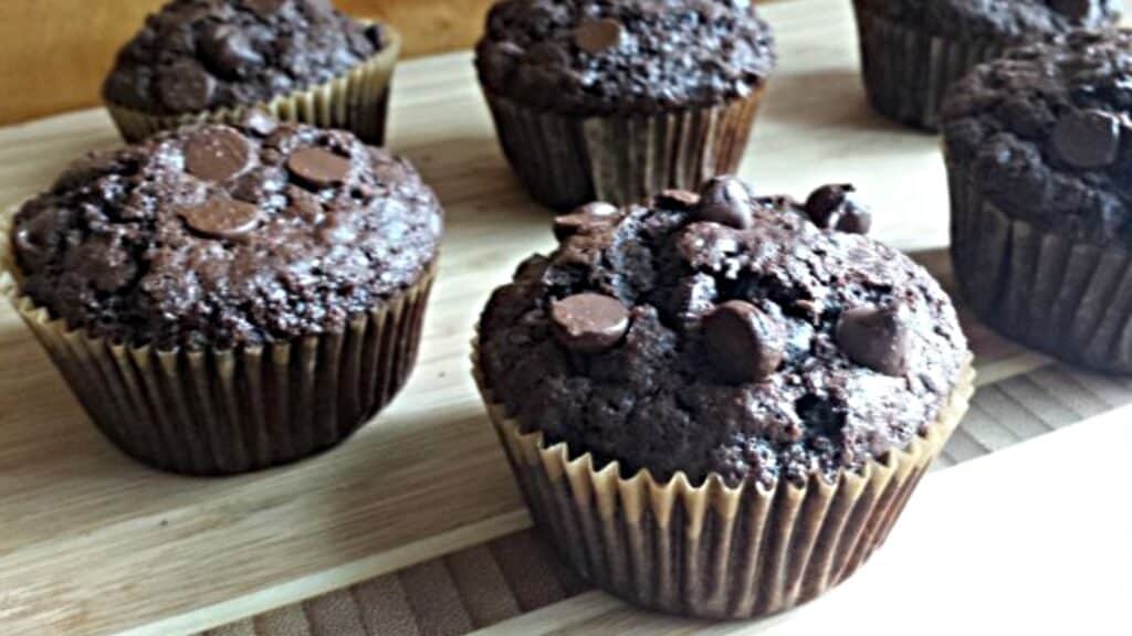 Dairy free chocolate chip muffins on a wooden cutting board.