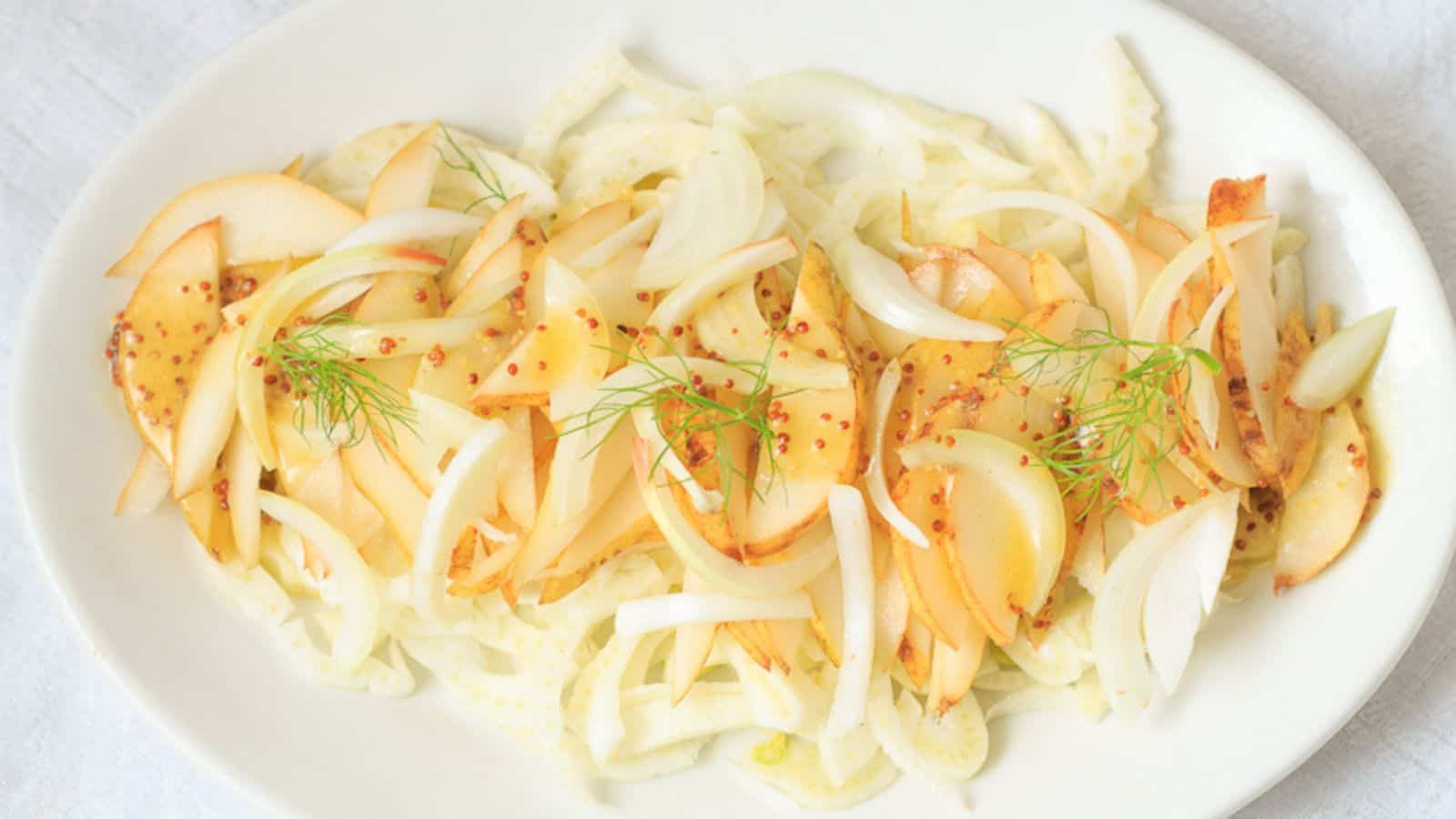 Fennel salad with pears on white platter.