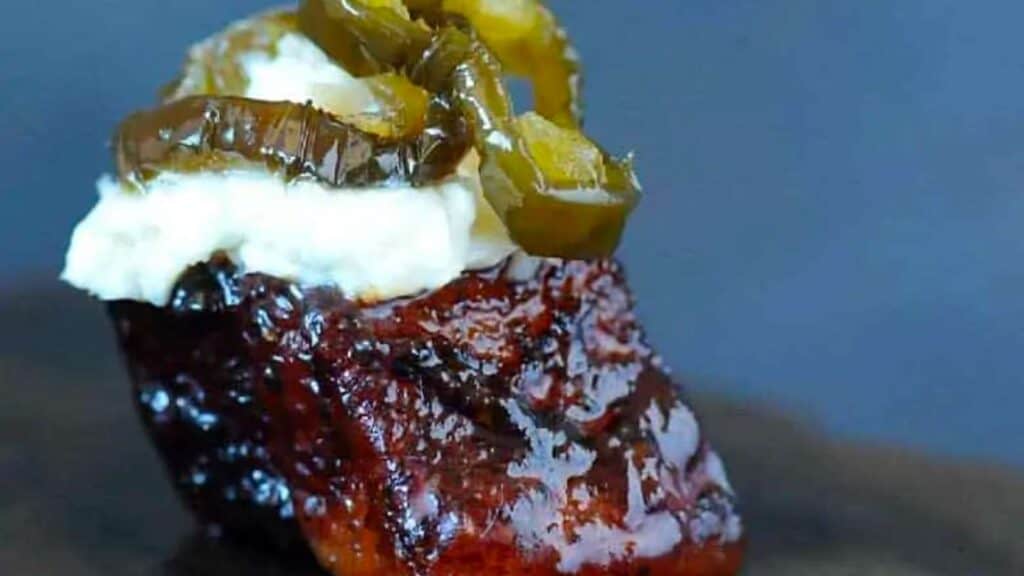 Pork belly burnt end with garlic cream cheese and candied jalapeno on top.