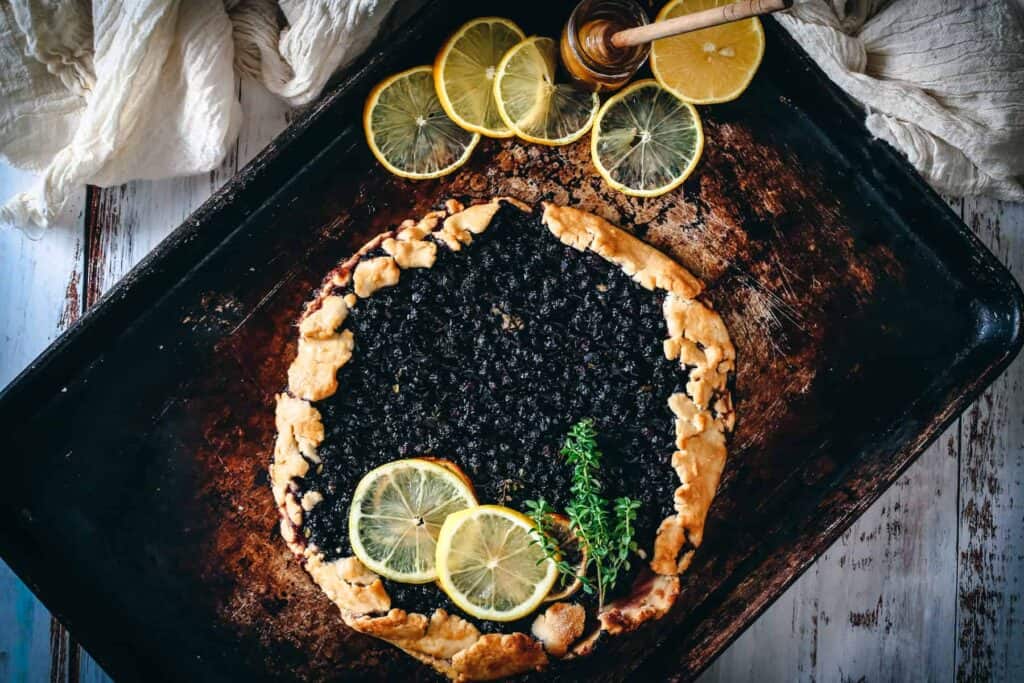 blueberry galette with lemon slices on top.