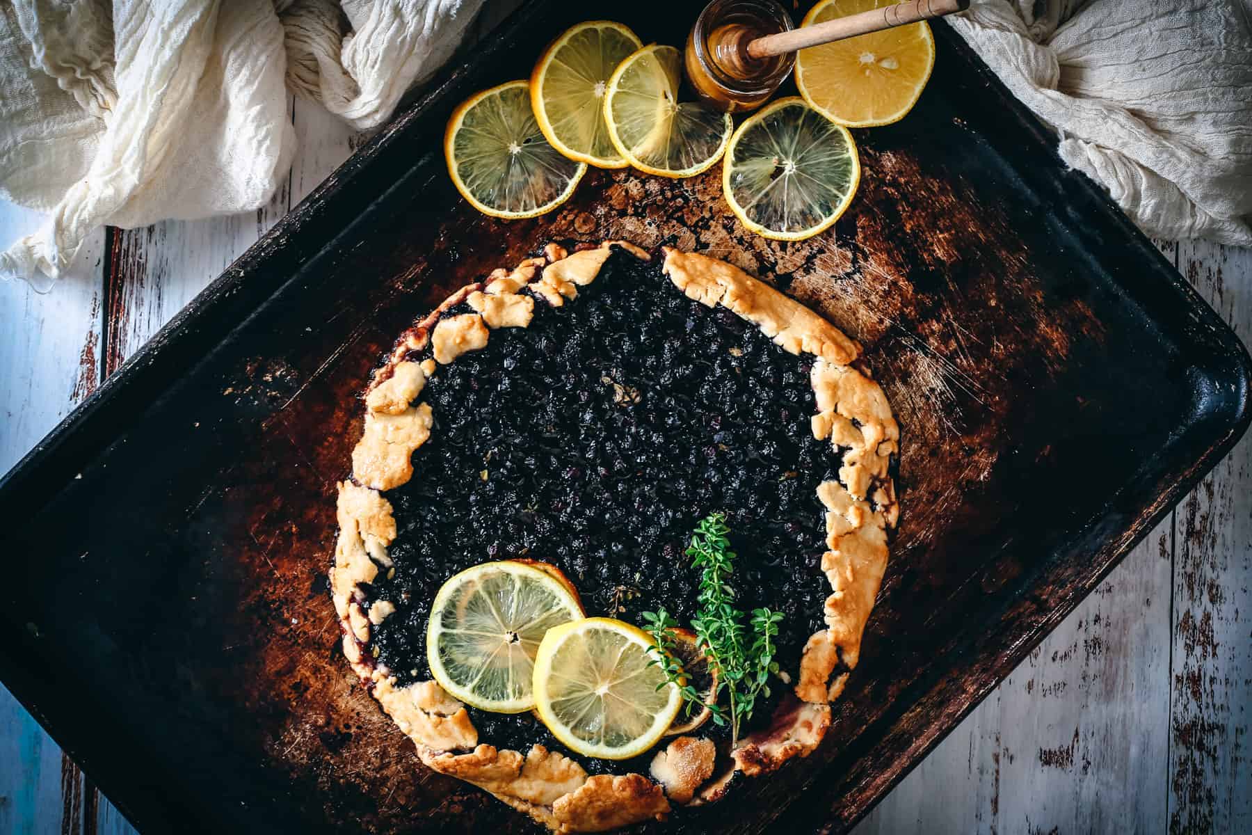 Blueberry galette with lemon slices on top.